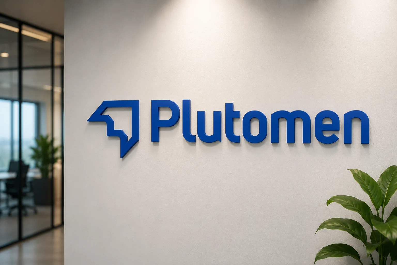 The new Plutomen wordmark on an office wall